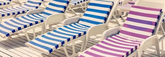 Blue deck chairs at the swimming pool photo