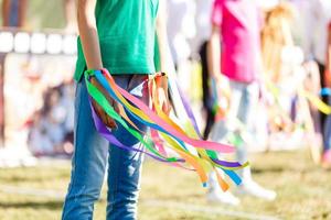 multicolored ribbons in hands photo