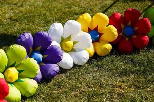 Festive composition of inflatable balloons in the form of multicolored flowers photo