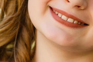 Cute little girl smiling in a park close-up photo