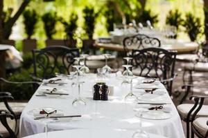 Served table with glasses in restaurant. photo