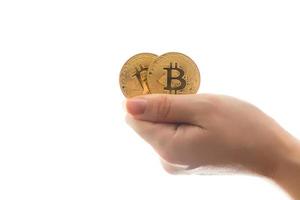 Two golden bitcoin in  hand digitall symbol of a new virtual currency isolated on white photo