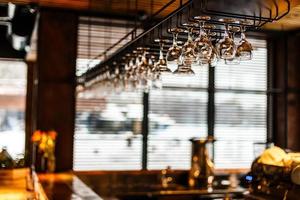 different glasses hanging over the bar. Soft focus photo