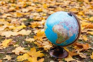 globe in an autumn park photo