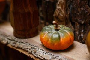 Pumpkin and autumn leaves on a old wooden table photo