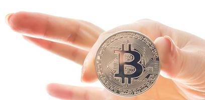 hand holds three coins of digital currency bitcoin photo