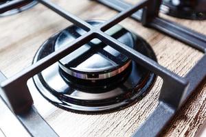 Dirty gas stove burners in kitchen room, close-up shooting. photo