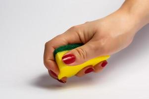 Woman hand holding a cleaning sponge isolated on a white background photo