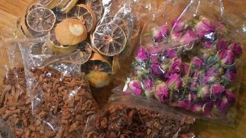 Dried tea leafs and flowers in plastic bags  before preparation in Iran video