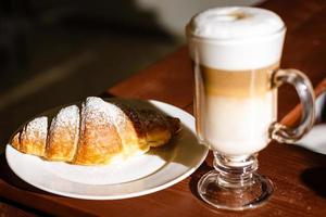 Fresh croissant on a black slate background. Copy space photo