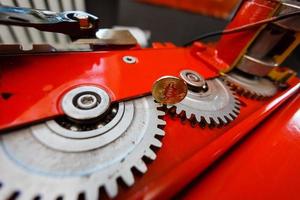 Gears and cogs close up and bitcoin coin photo