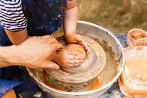 A close-up of the child learns to knead the clay photo