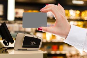 Cashier holding credit card in cash register photo