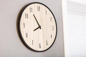 Five minutes to eight o clock on the dial round wall clock photo