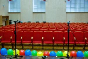 Microphone over the abstract blurred of conference hall or seminar room background photo