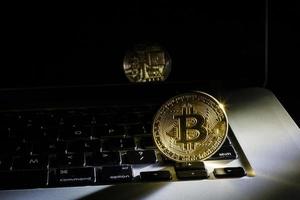 Golden bitcoin new currency, accepting bitcoin for payment, finance concept, laptop copy space photo