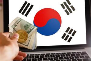 Bitcoin close up on keyboard background the flag of south korea is shown on bitcoin photo