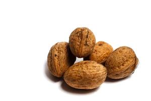 walnuts pyramid over the white background photo