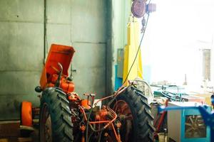 Tractor engine rear view oil machinery technology industry manufacturing wires steel tire photo