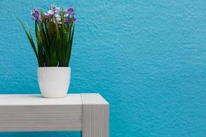 white flowerpot on blue background minimal concept idea photo