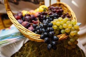 Apples plums and grape on a wooden background freshly washed on a plate photo