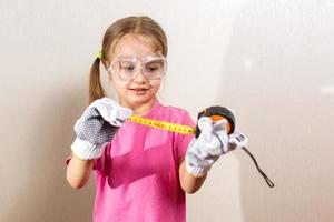 Little girl holding a meter isolated on white background the concept of development of the child photo