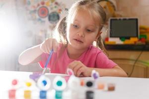 Little girl drawing closeup shot photo