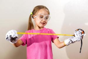 Little girl holding a meter isolated on white background the concept of development of the child photo