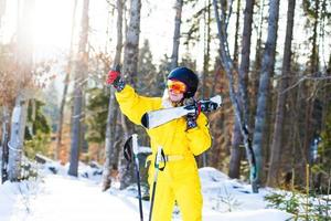 Woman skier enjoy in winter sunny day, holiday photo