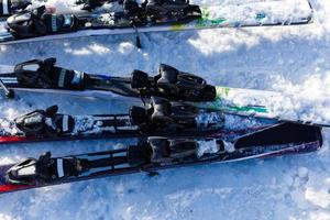 Skiing, winter season , mountains and ski equipments on ski run photo