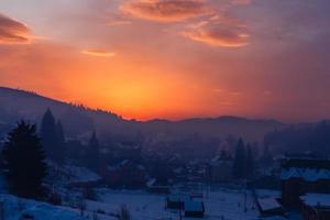 Colorful autumn morning in the Carpathians. Dramatic sunrise in the mountain village. Artistic style post processed photo. photo