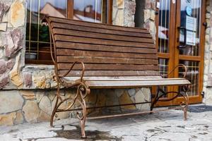 Vintage wooden garden bench with metal swirls photo