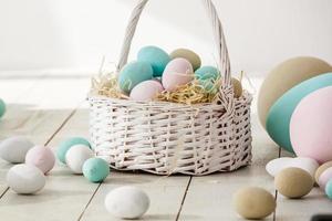 Easter eggs basket wooden background photo