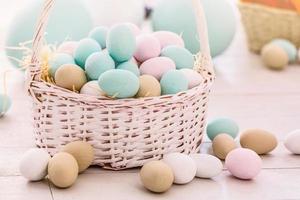 Easter eggs in the nest on rustic wooden background photo