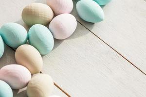 Coloeful easter eggs in nest on pastel color background with space. photo