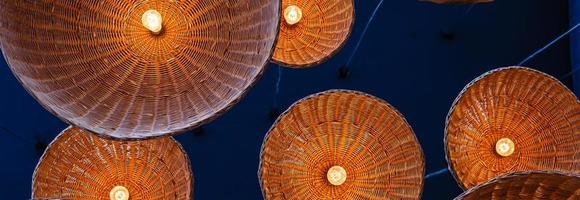 lamps in straw shades on the ceiling for decoration photo