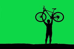 silhouette of a person riding a bike photo