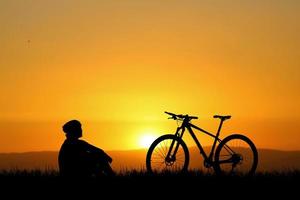 Silhouettes of bikes and cyclists travel concept and exercise by bicycle photo