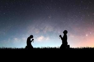 Man praying with hope against Milky Way background photo