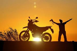 Man traveling freely with a motocross bike. motorcycle travel concept photo