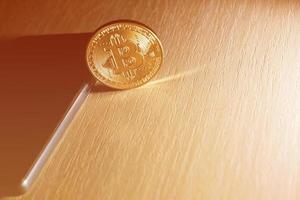 Close up of a golden bitcoin currency and a smart phone photo