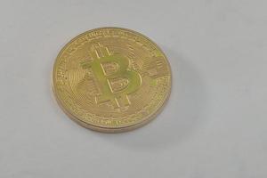 Gold coin of bitcoin on a gray background photo