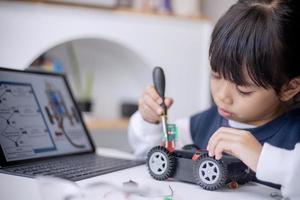 Asia students learn at home in coding robot cars and electronic board cables in STEM, STEAM, mathematics engineering science technology computer code in robotics for kids concept photo