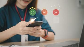 smart woman use smartphone choosing green happy smile face icon. feedback rating and positive customer review experience, satisfaction survey. mental health assessment. world mental health day concept photo