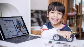 Asia students learn at home in coding robot cars and electronic board cables in STEM, STEAM, mathematics engineering science technology computer code in robotics for kids concept photo
