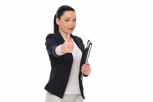 Happy business woman showing thumb up and looking at the camera over gray background photo