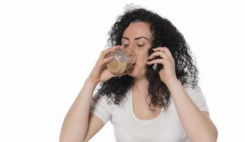 portrait of young woman drinking coffee at table photo