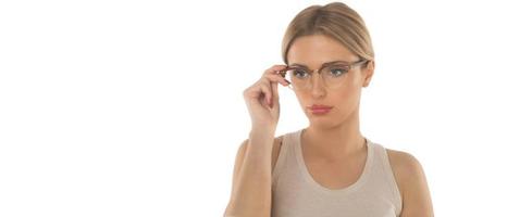 a young woman chooses a frame for her new glasses on white background photo