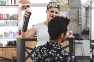 Professional hairdresser is cutting men's hair in beauty salon. photo