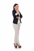 Happy business woman showing thumb up and looking at the camera over gray background photo